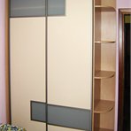 Sliding door wardrobe has utility side shelves